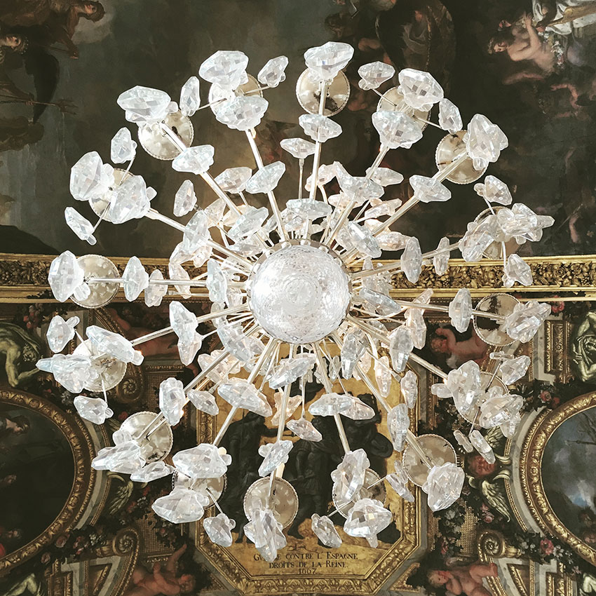 Shot from directly under a chandelier in the palace of Versailles