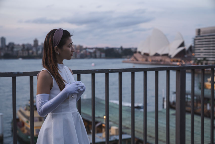 Medium shot of me with long white gloves and the Opera House in the background