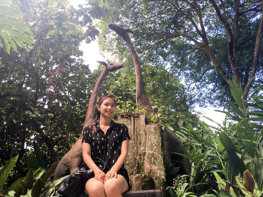 Low angle shot of me sitting in front of some giraffe sculptures