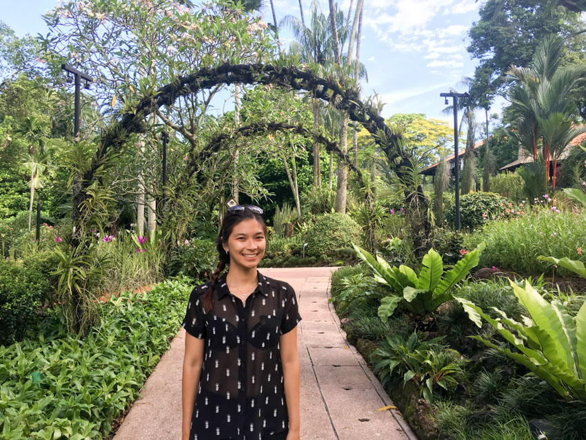 Medium shot of me standing on a path with some garden arches