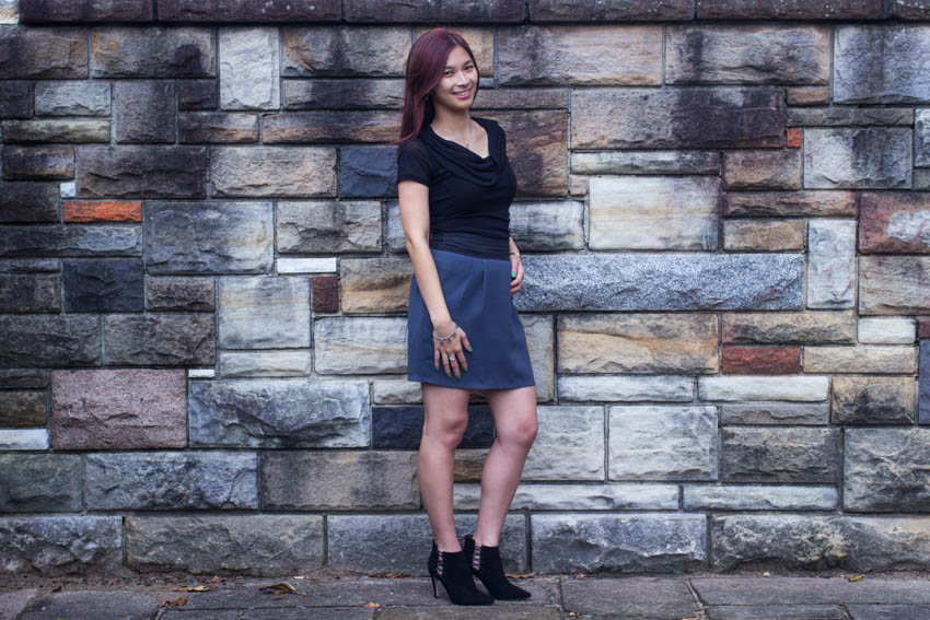 Full body shot of an effortless outfit, standing against a wall