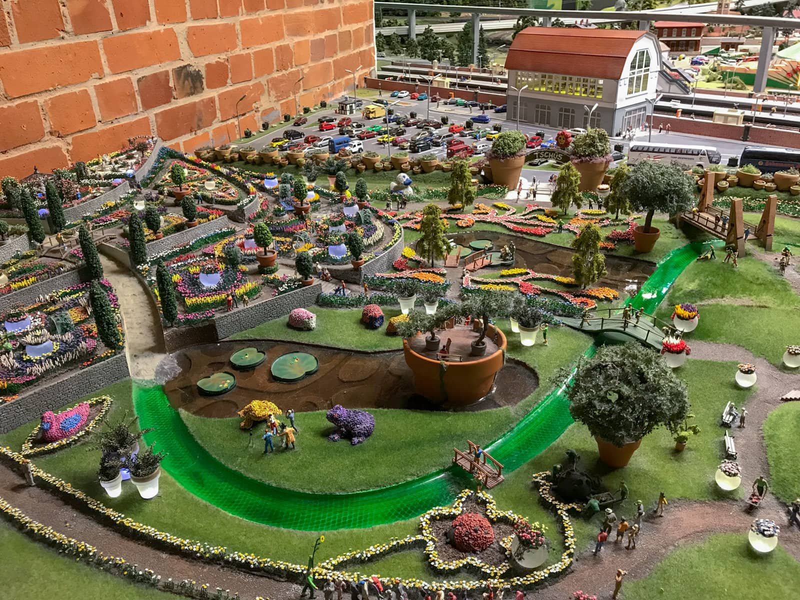 Another miniature replica of a garden with green lawns and tiny colourful plants