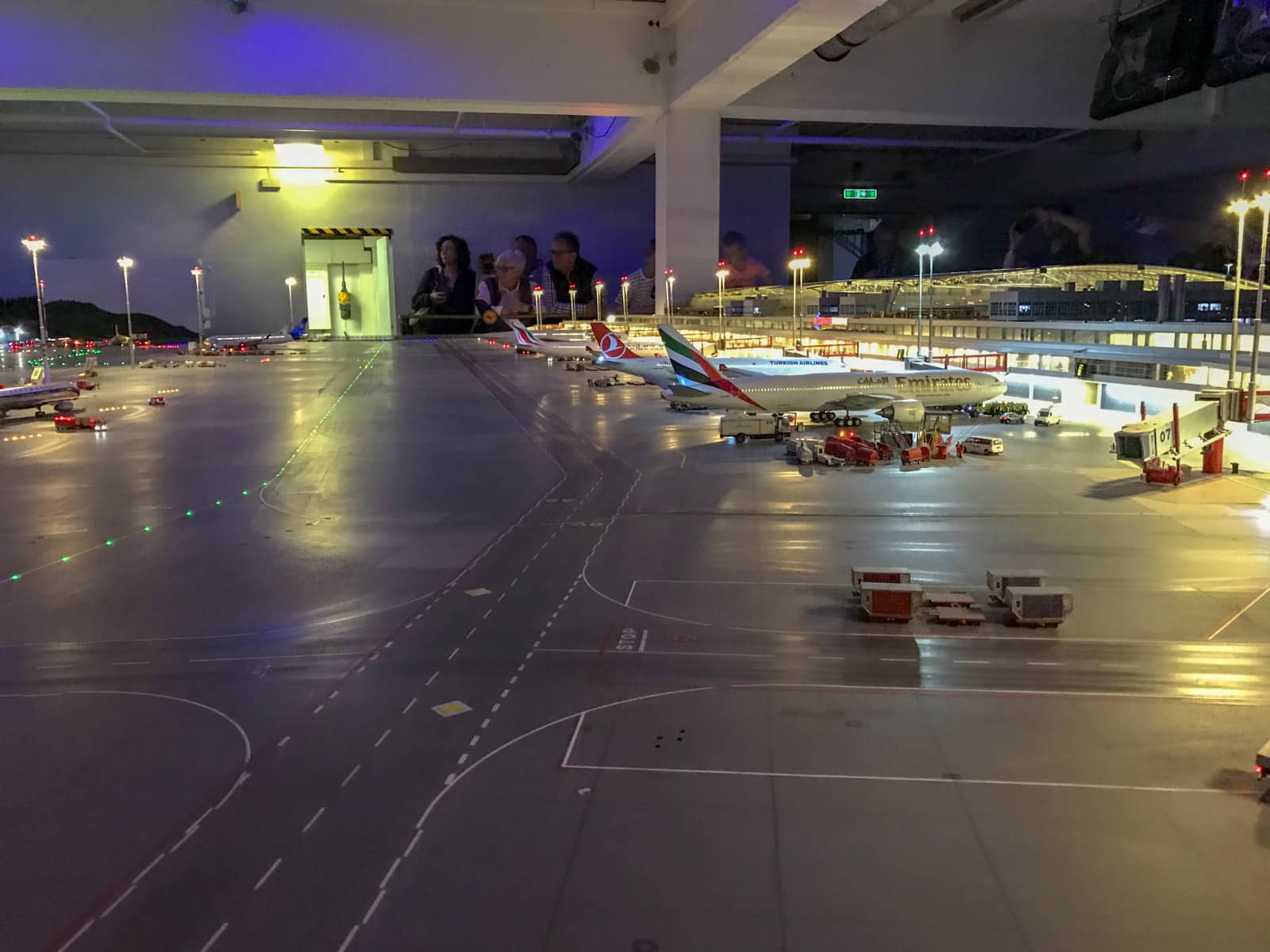 A model airport as part of an indoor model railway. The lights are off to simulate night-time