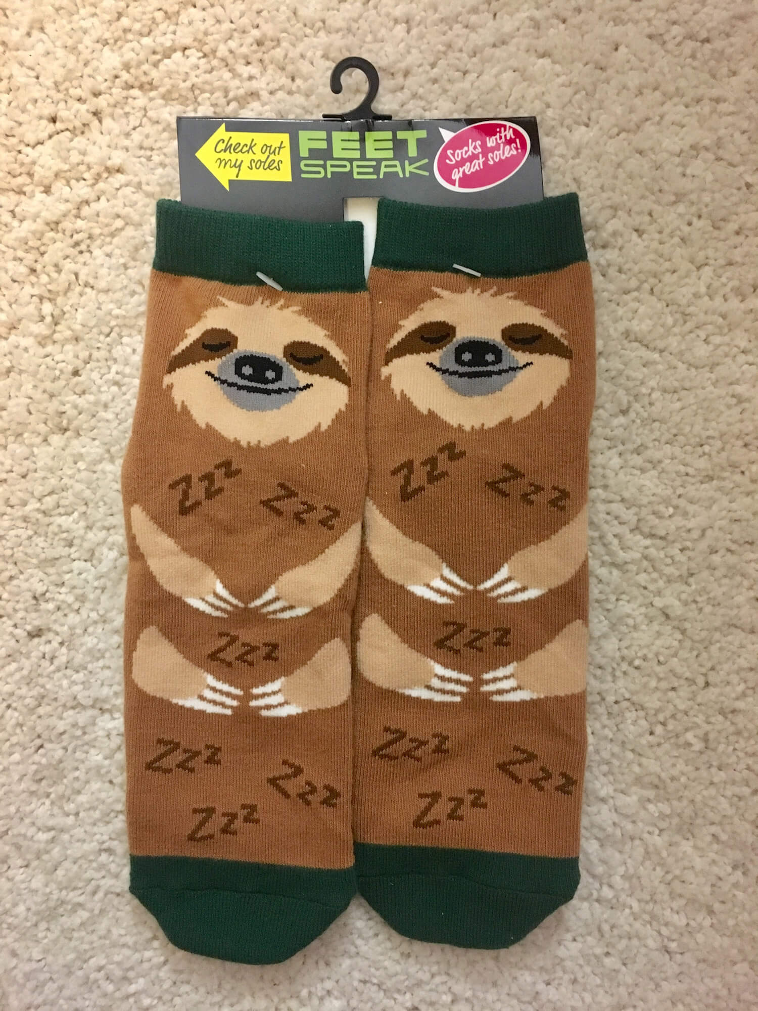 A pair of socks made to look like sleeping sloths