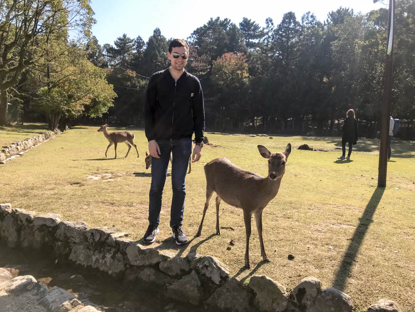 Nick standing next to a deer