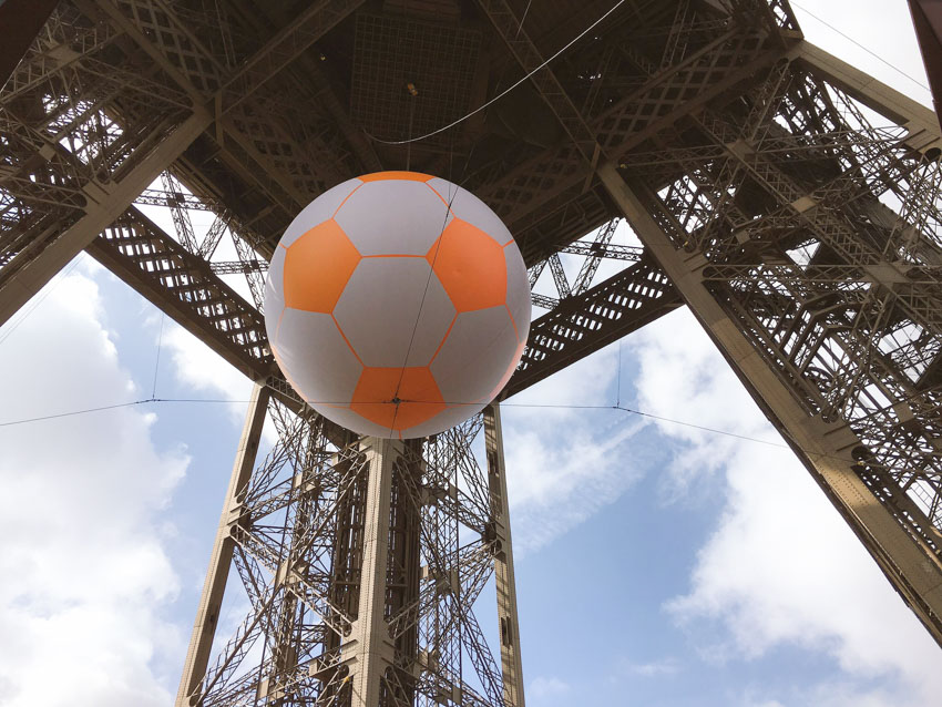 A big inflatable football hanging from the centre of the Eiffel Tower for Euro2016