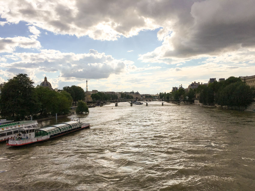 The Seine as seen from a bridge, with a cloudy afternoon sky