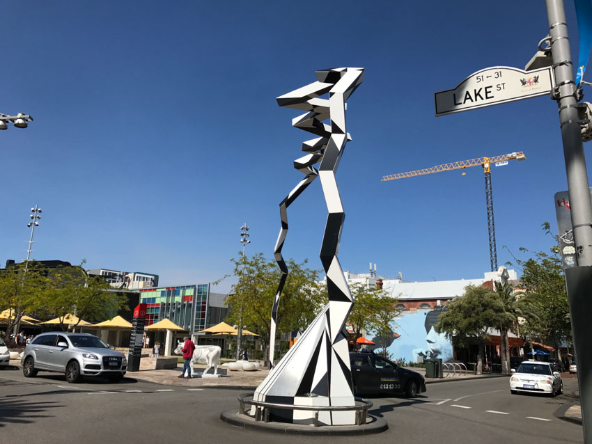 Black and white sculpture in the middle of a roundabout