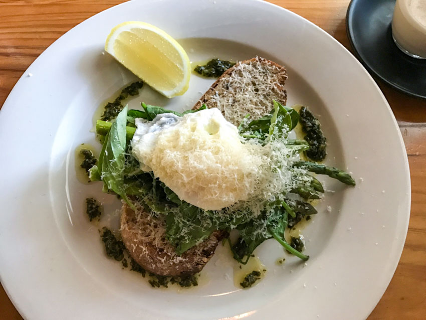A plate of asparagus and poached egg on sourdough