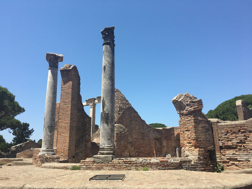 Stone pillars by a broken-down building