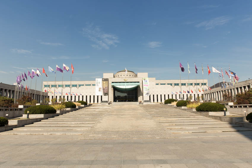 The war memorial entrance with the flags of various nations