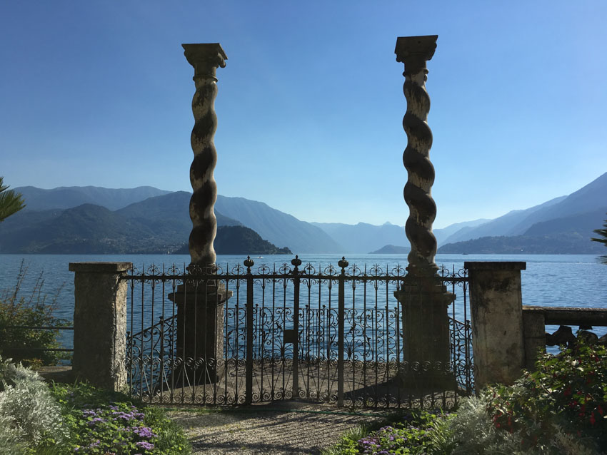 Close up shot of the two twisted pillars at Villa Monastero, with the lake in the background