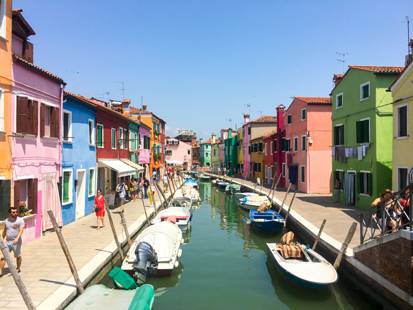 A waterway in Burano with coloured houses down the sides