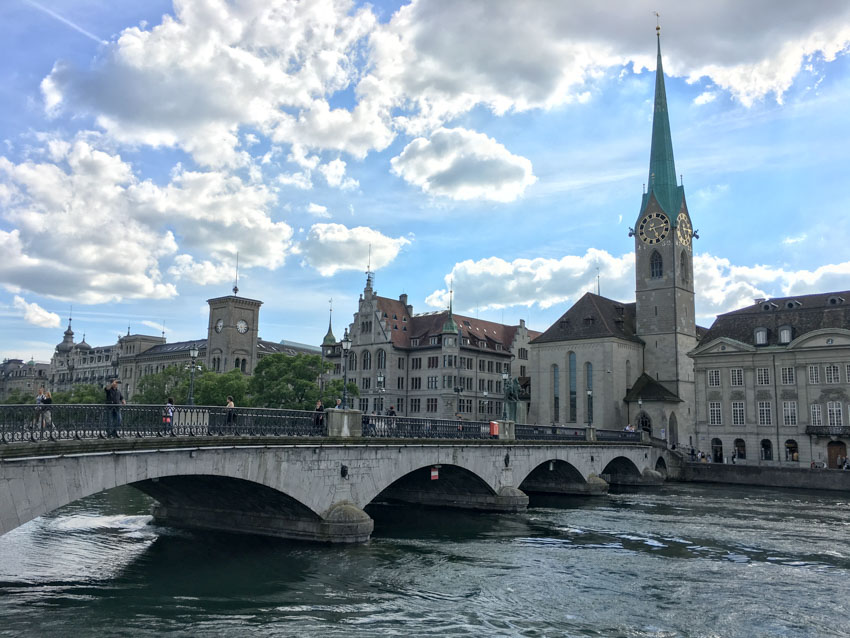 Medium shot of a bridge in Zurich with a tall clock tower