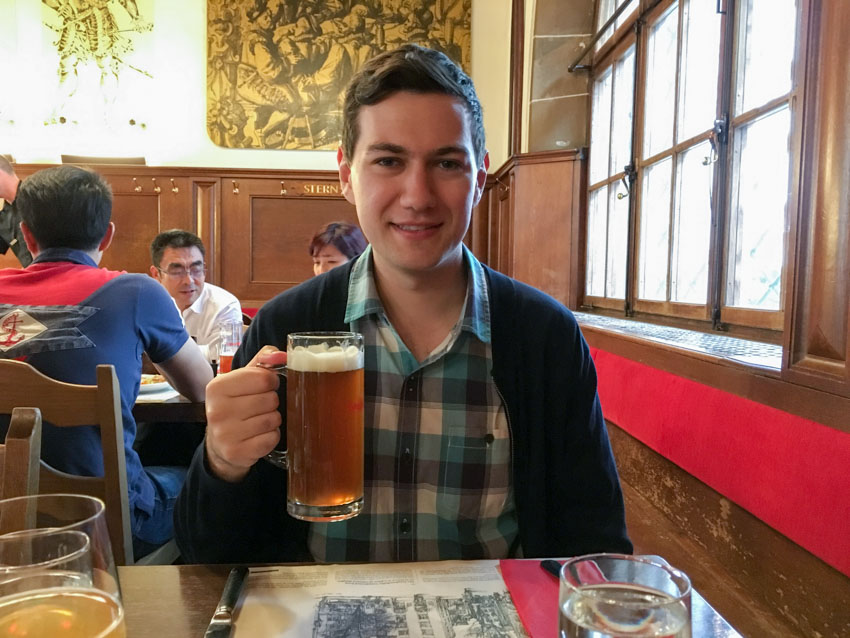 Nick holding up a large mug of house beer