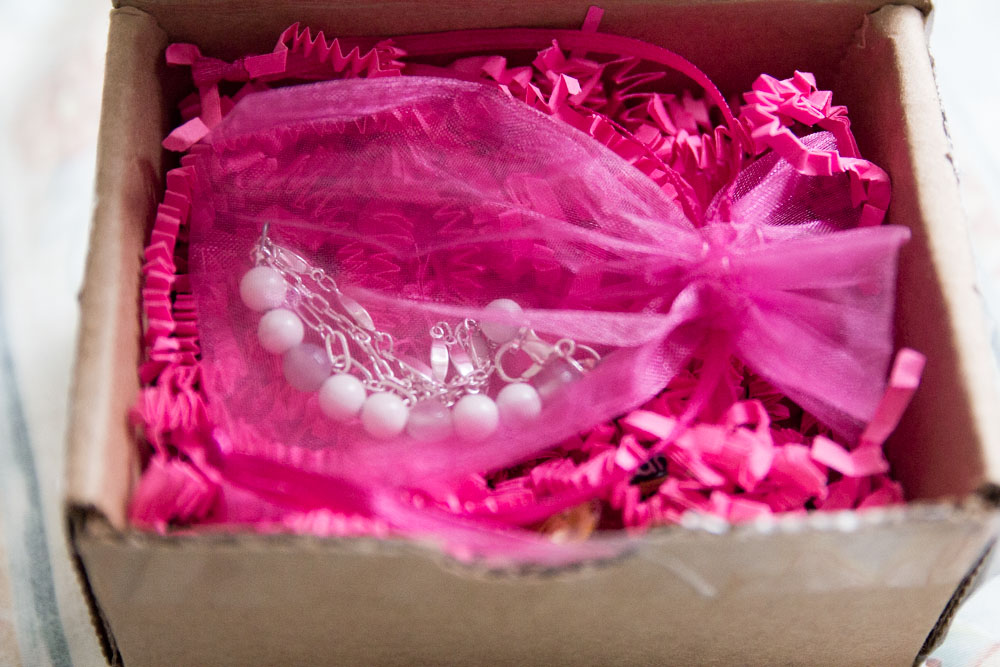 The bracelet in a pink organza bag
