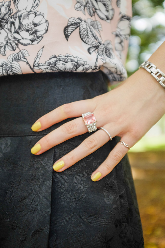 Pink ring and yellow nails.