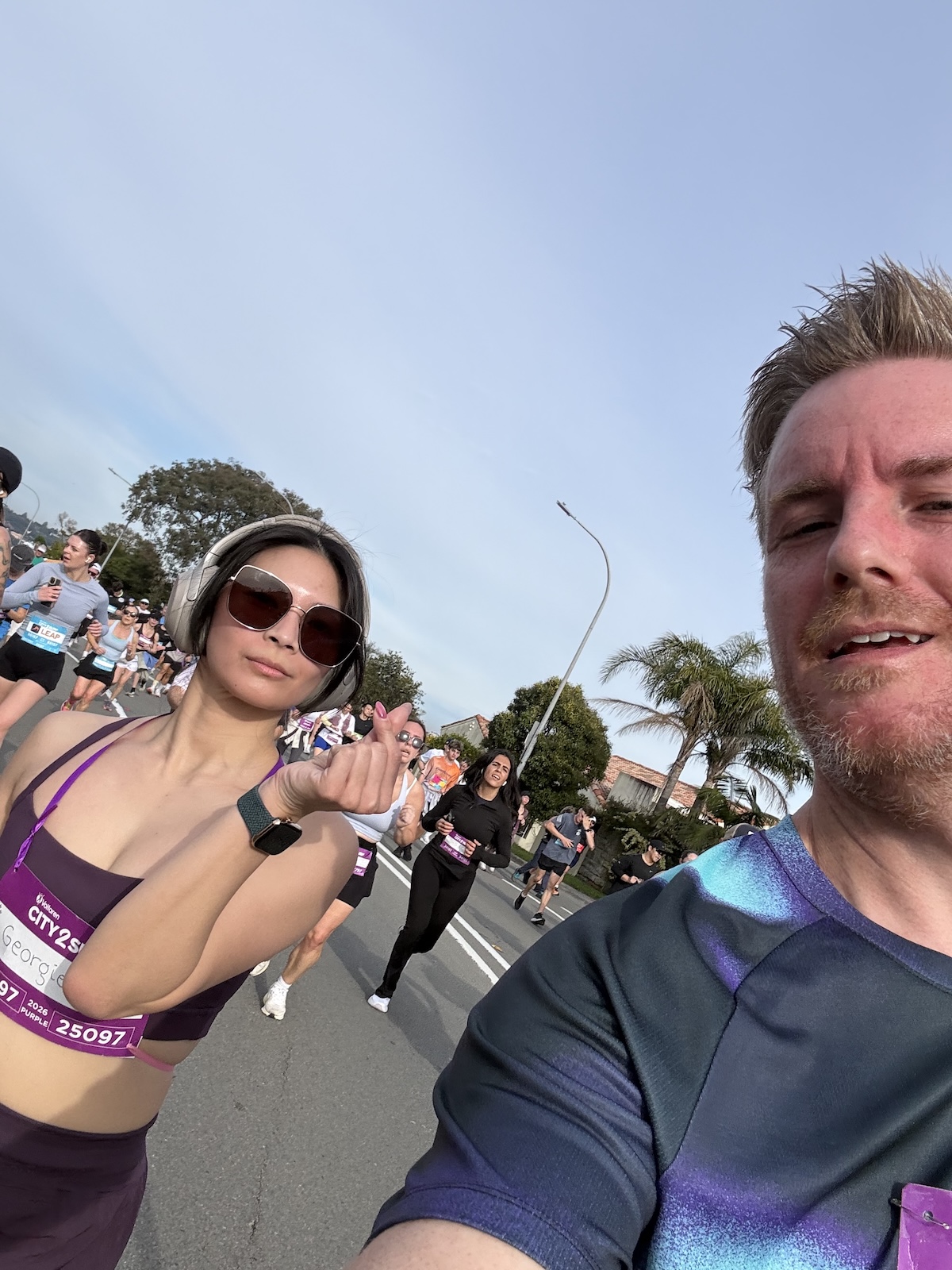 A selfie of me and Chris, me looking serious and making a small heart sign with my thumb and index finger, and Chris also looking serious and as if he is leaning back