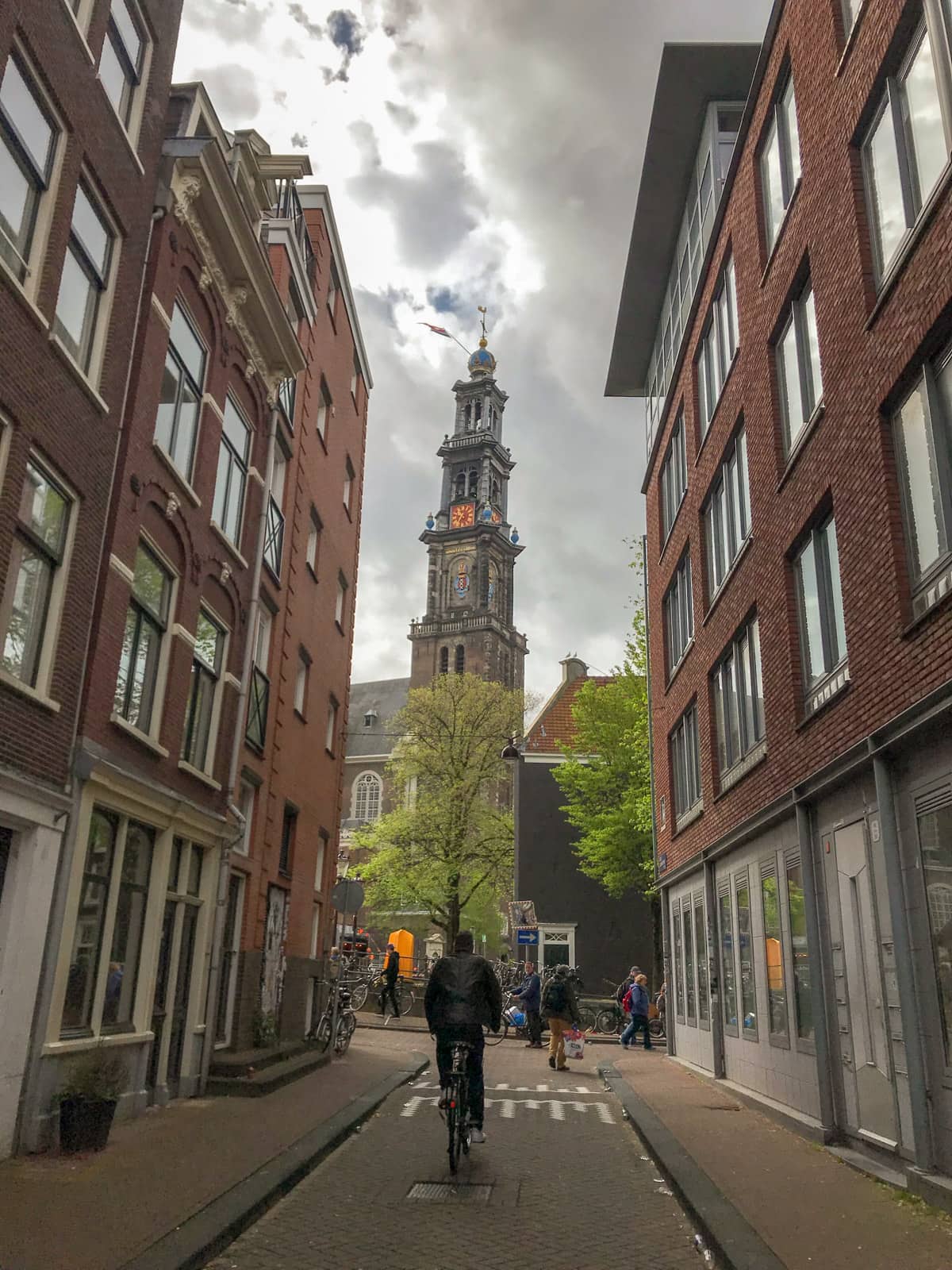 A tower as seen from street level and visible between two buildings in the foreground