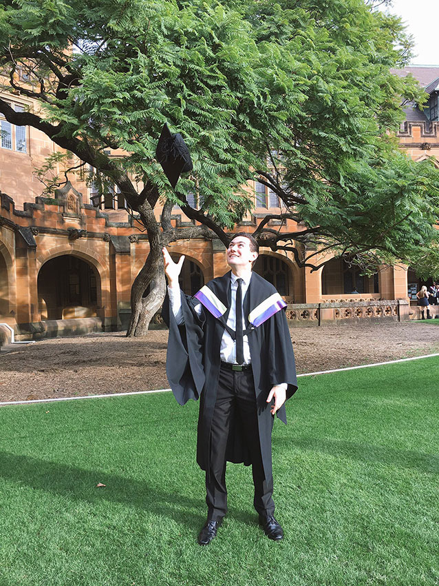 Nick throwing his graduation hat in the air