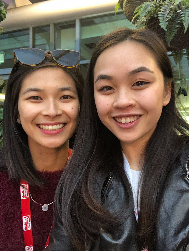 Two women with dark hair, smiling