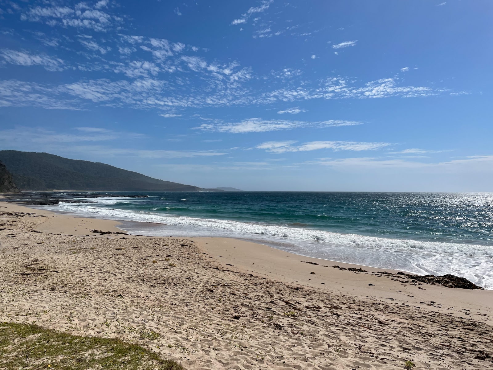 A yellow sand beach with blue waters