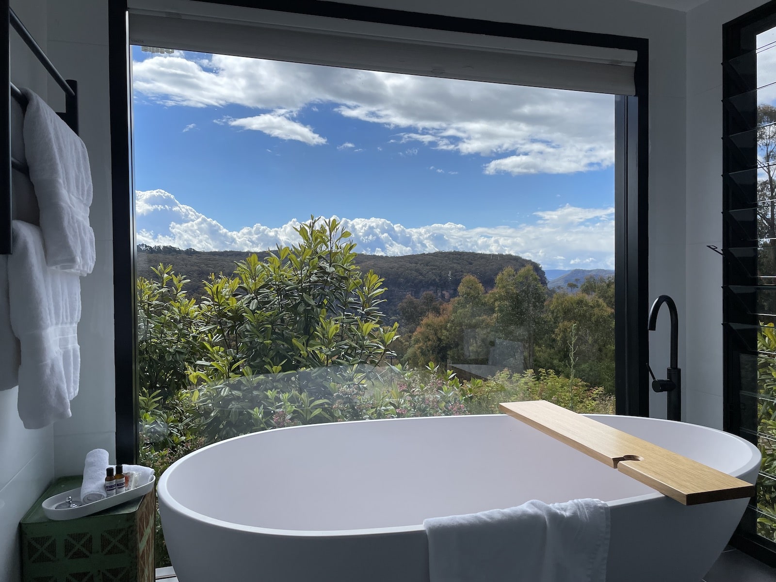 A white indoor bathtub with a view looking out to the mountains