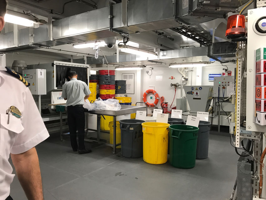 Crew members sorting garbage into bins of different types