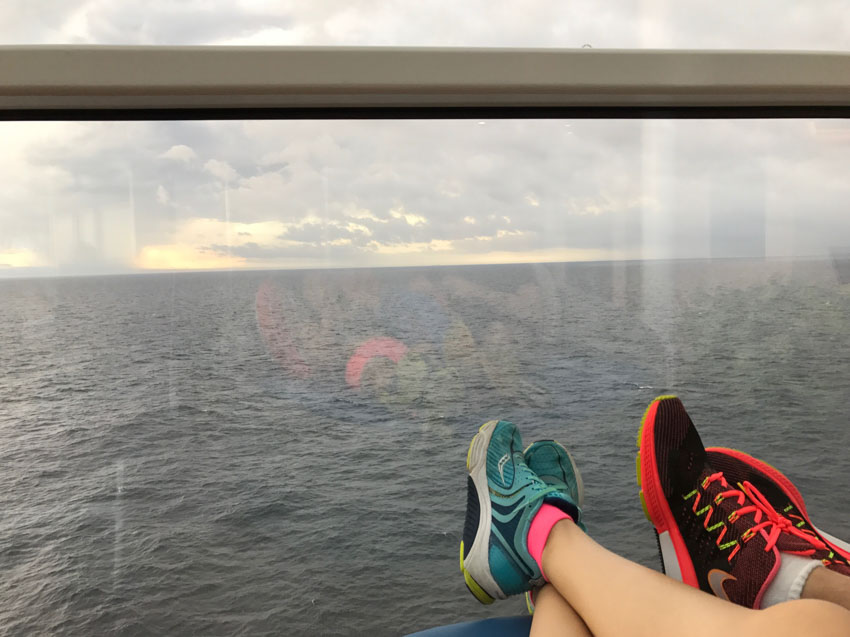 My feet and Nick’s feet with our running shoes on, outstretched with the ocean in the background