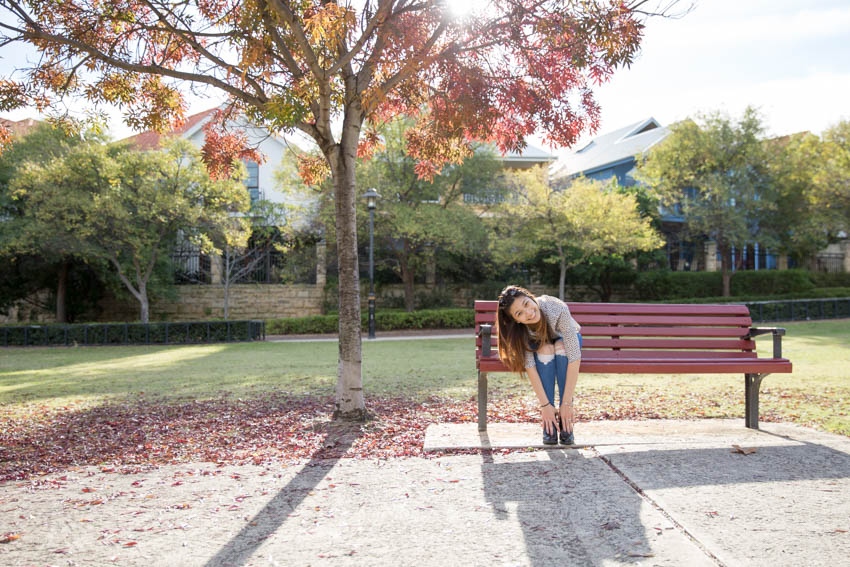 Me sitting on a park bench reaching down to my feet