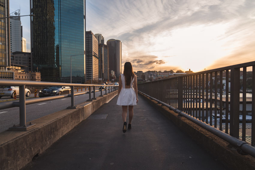 Me walking down the side of a highway with Circular Quay down one side