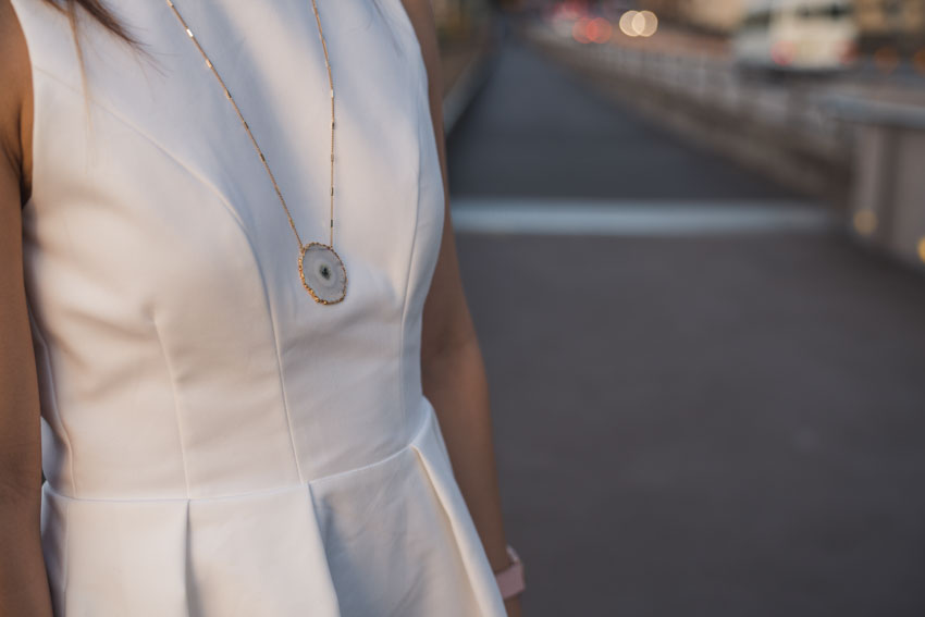 Close up of gold solar necklace