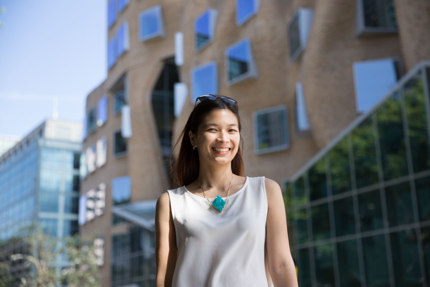 Low angle shot of me smiling with the university building in the background