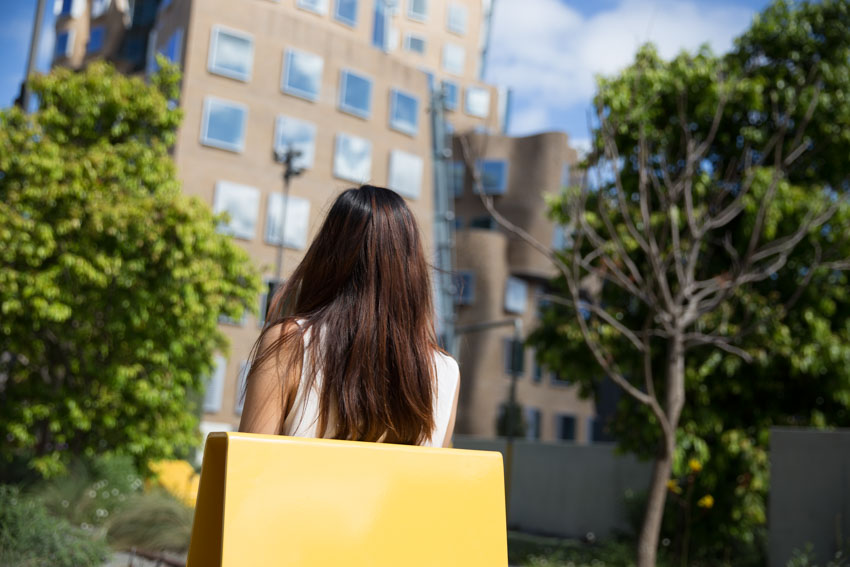 Shot from behind my head, of the back of my head with the university building in the background