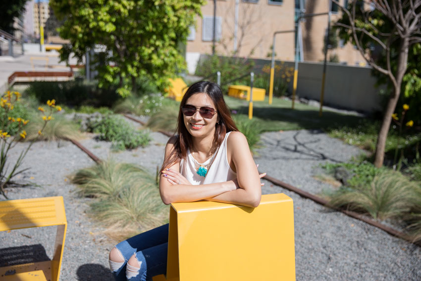 Me leaning over the edge of a yellow chair, with my sunglasses on