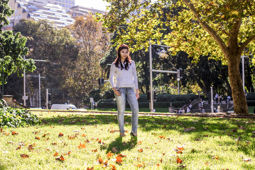 Me standing in the middle of the park with scattered autumn leaves on the ground