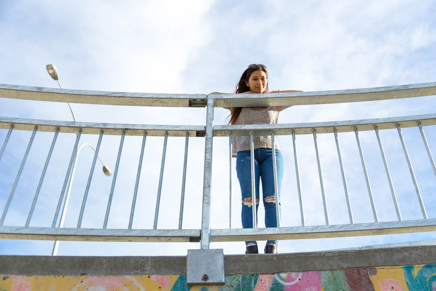 Me leaning over a metal railing on an overpass