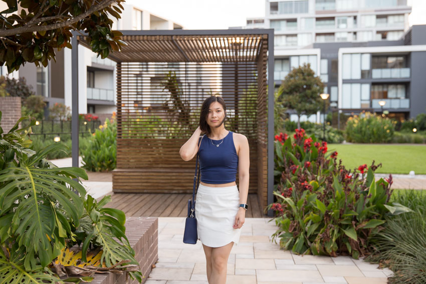 Front-on shot of the wind blowing my hair while I try to hold it back with my right hand