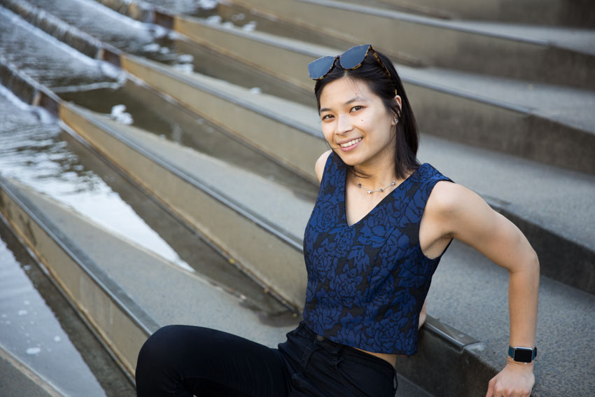 Me sitting on some concrete steps with a water feature in the background