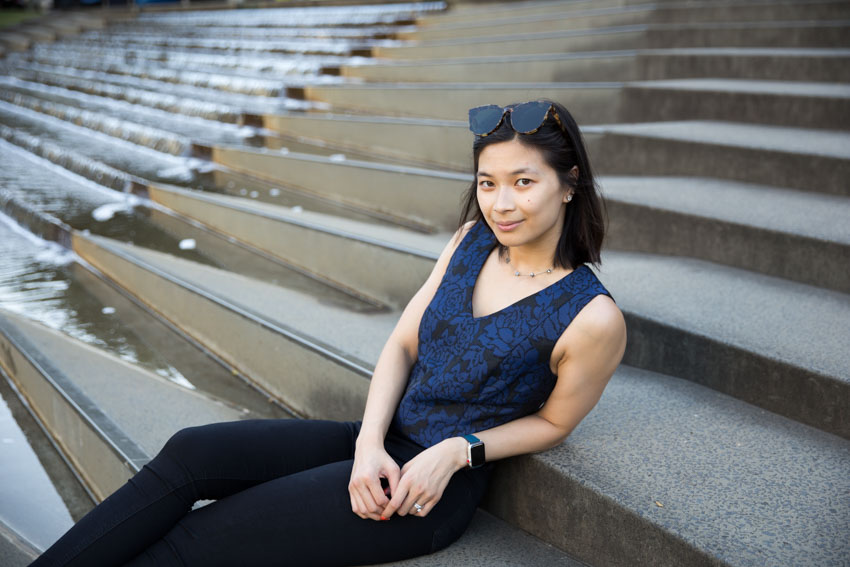 Me sitting on some concrete steps with a water feature in the background