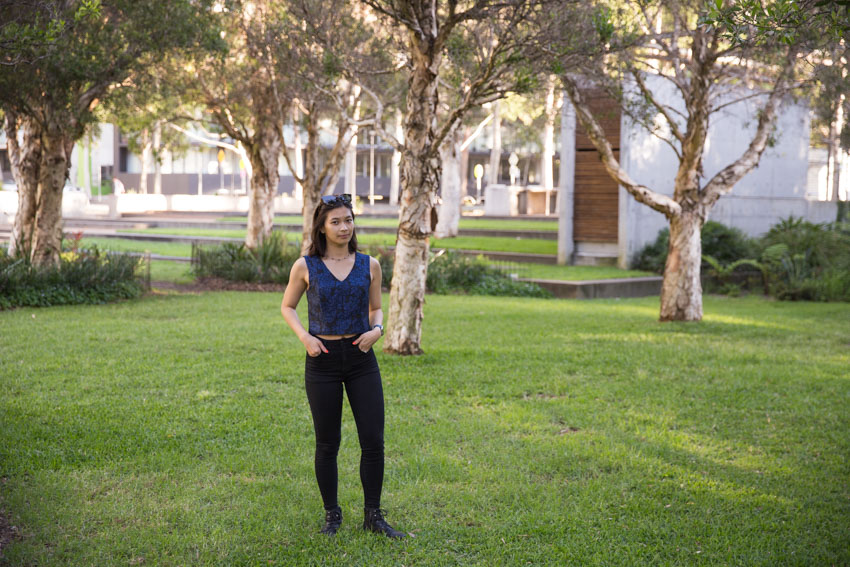 Me standing with my hands in my pockets amongst some trees in a park