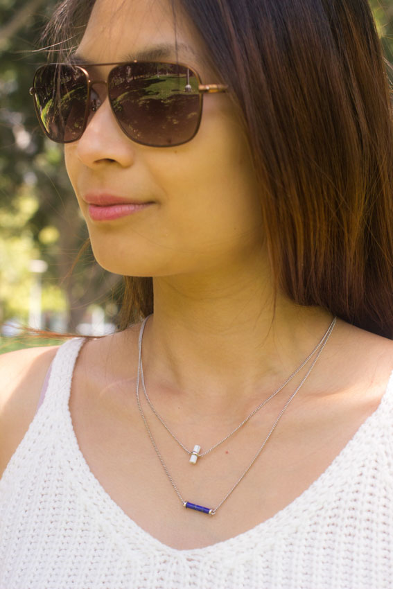 Close up of my face, wearing sunglasses and with my layered necklace visible