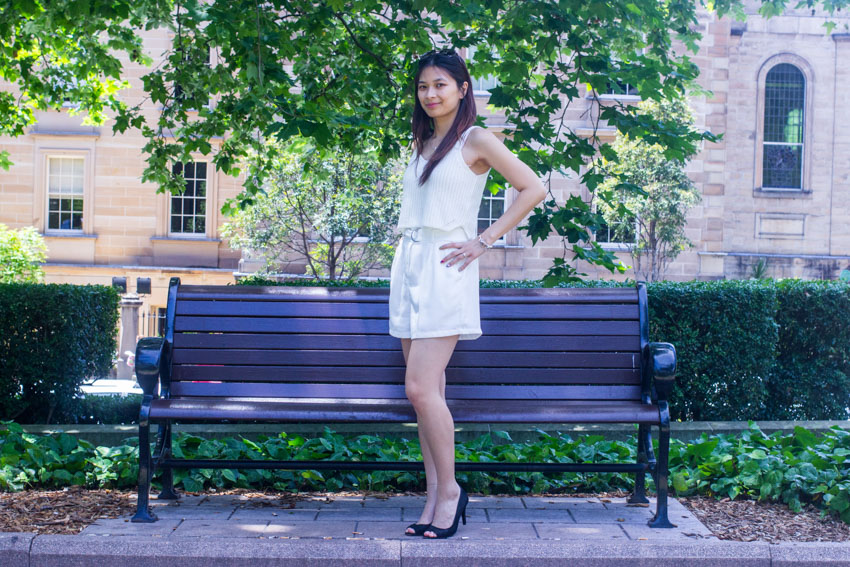 Full body shot of me standing in front of a bench with a hand on my hip