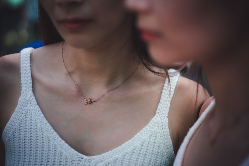 Close up of rose gold origami crane necklace