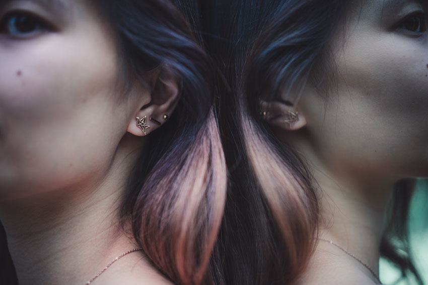 Close up of rose gold origami crane stud earrings