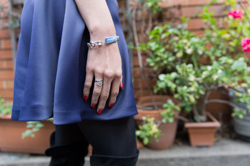 Close up of kyanite bracelet and ring against the navy of my skirt
