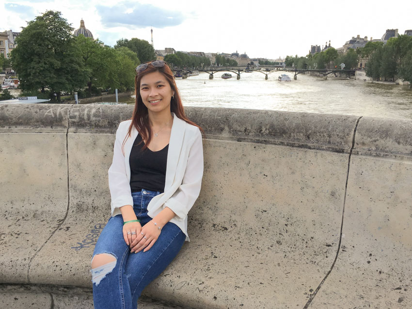 Sitting in a little seating area on a bridge overlooking the Seine