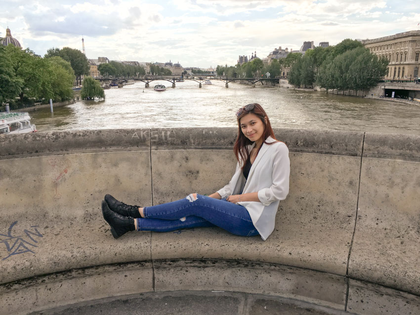 Sitting in a little seating area on a bridge overlooking the Seine