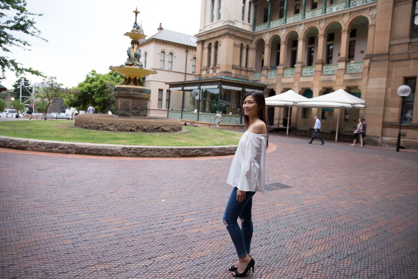 Full body shot with a fountain backdrop