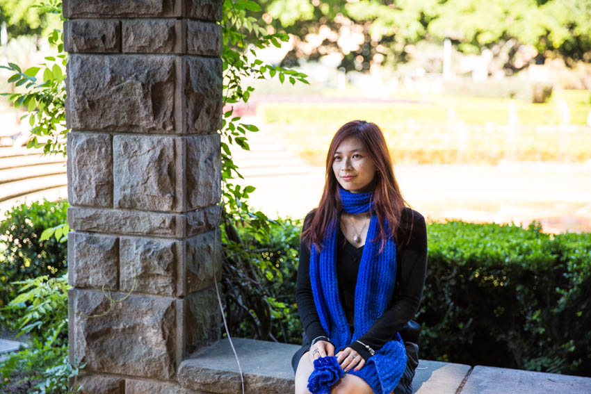 Me looking into the distance and away from the camera, sitting on a stone ledge